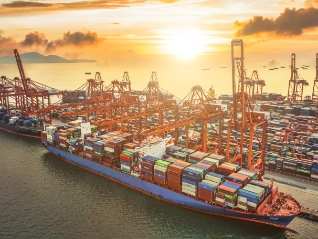 Aerial view of large ship in dock with containers