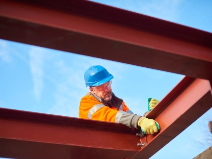 construction worker erecting girders
