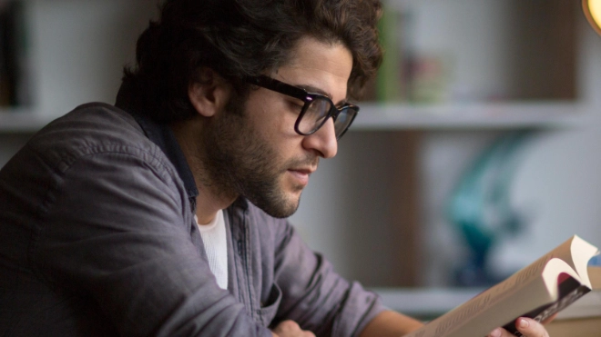 Knowledge and researching zoomed in image of man reading and using laptop