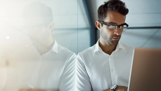 Young businessman working on his laptop in the office