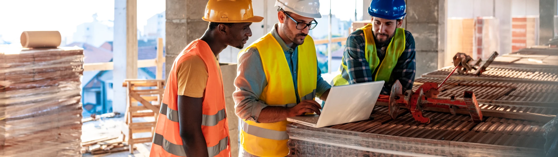 Construction workers on a building site reviewing site plans