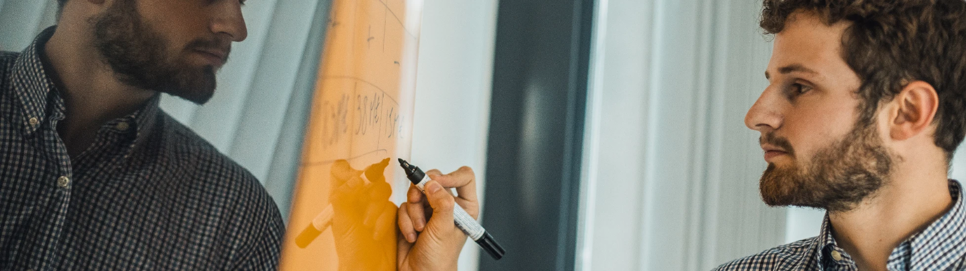 Atradius Colleague working on a board in the Paris Office