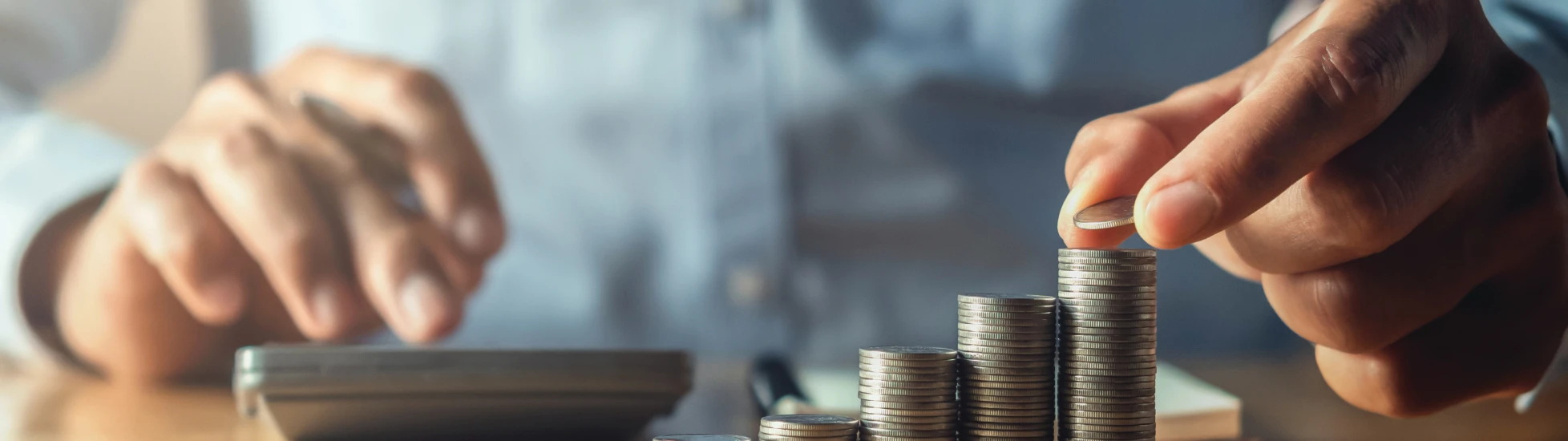 saving money with hand putting coins on stack concept financial