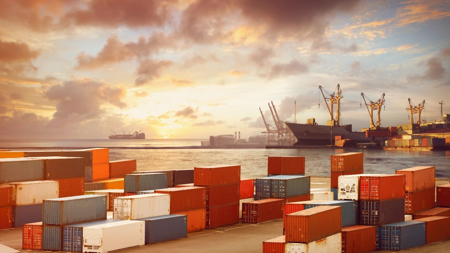 Shipping containers stacked up with sea in the background Shipping containers stacked up with sea in the background