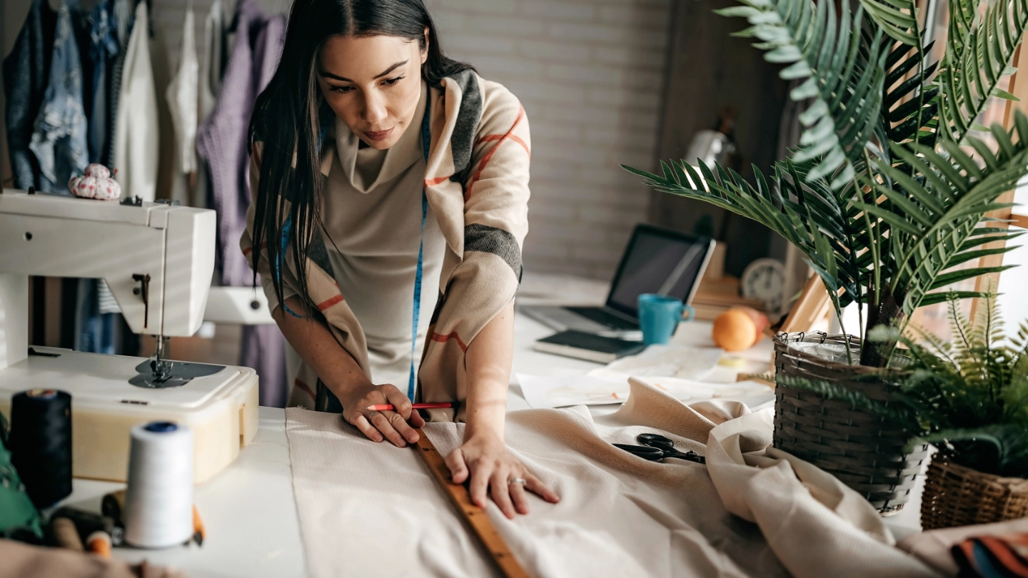 female textile worker cutting fabric seamstress female textile worker cutting fabric seamstress