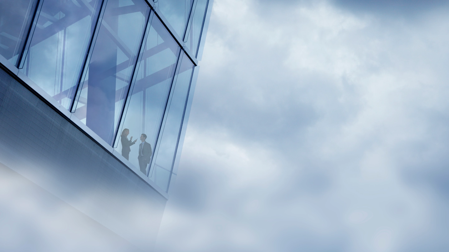 Two international workers in a high rise glass office Two international workers in a high rise glass office