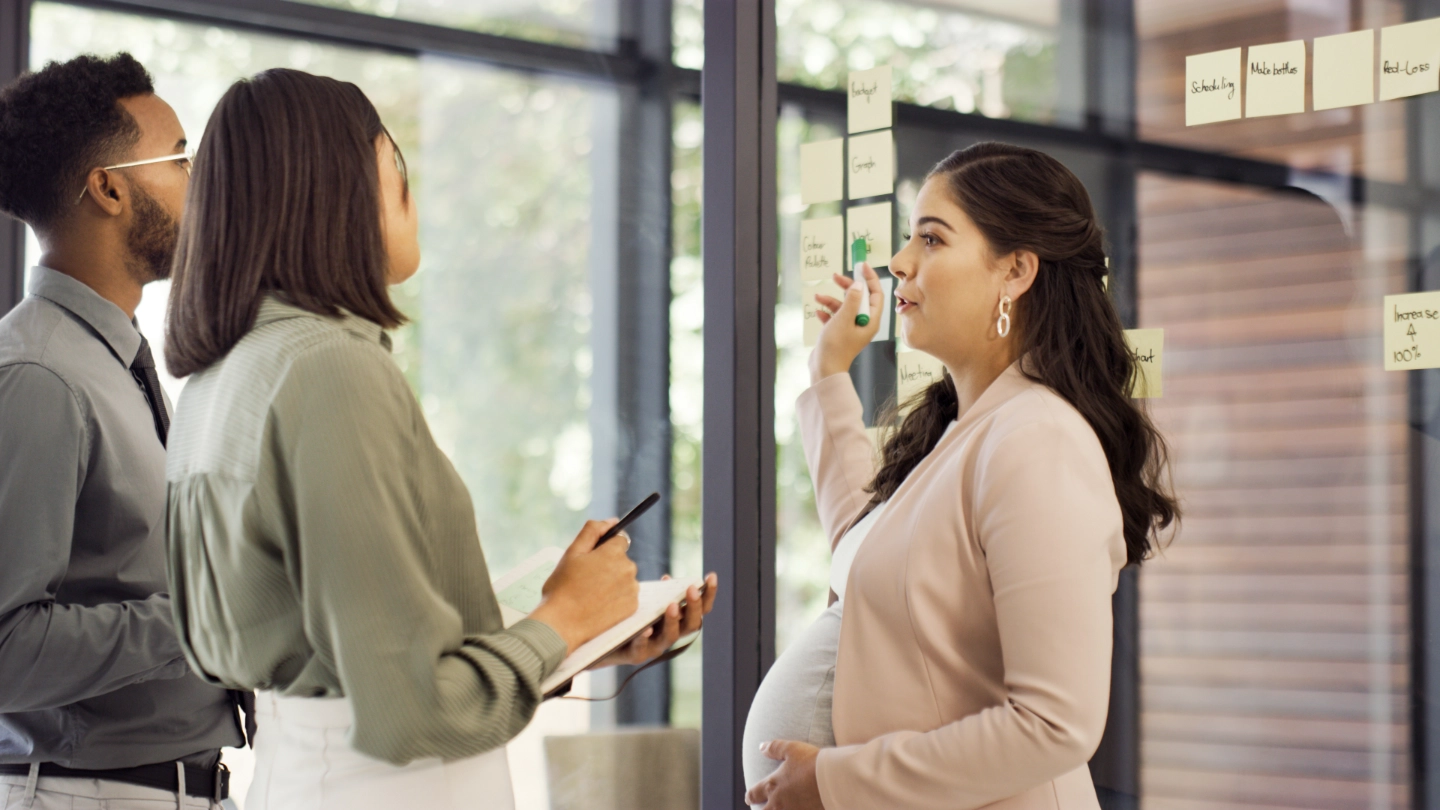 pregnant woman talking to woman and man pregnant woman talking to woman and man