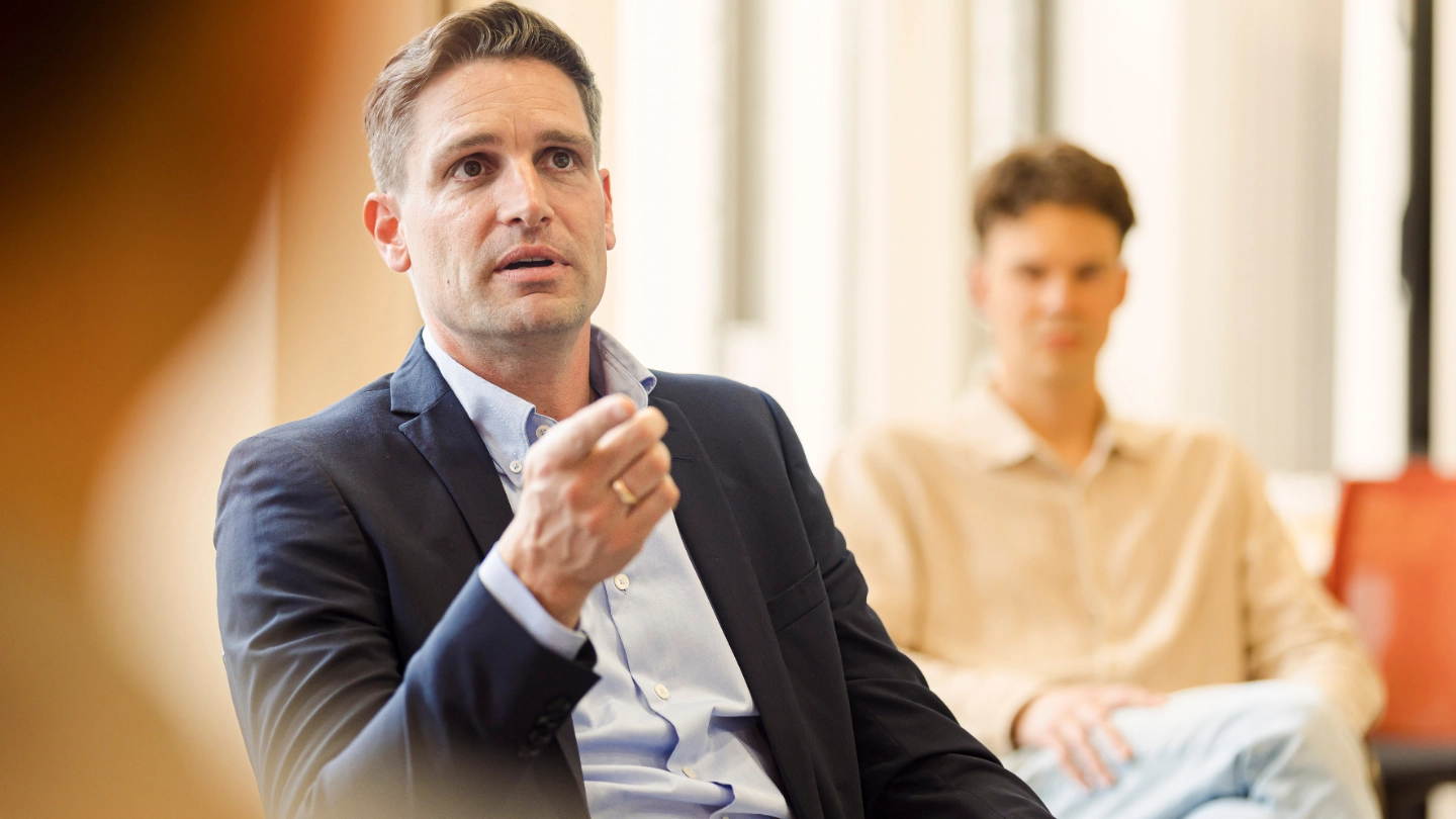 zoomed in man explaining in meeting in the office image