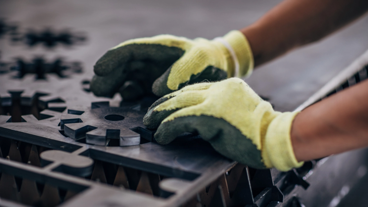 Close up of an engineer forming a metal component Close up of an engineer forming a metal component