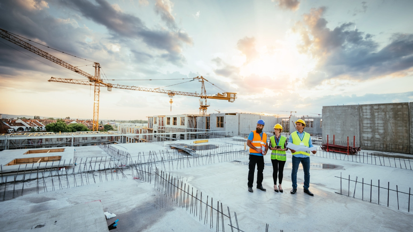 Group of construction workers on a roof top  Group of construction workers on a roof top