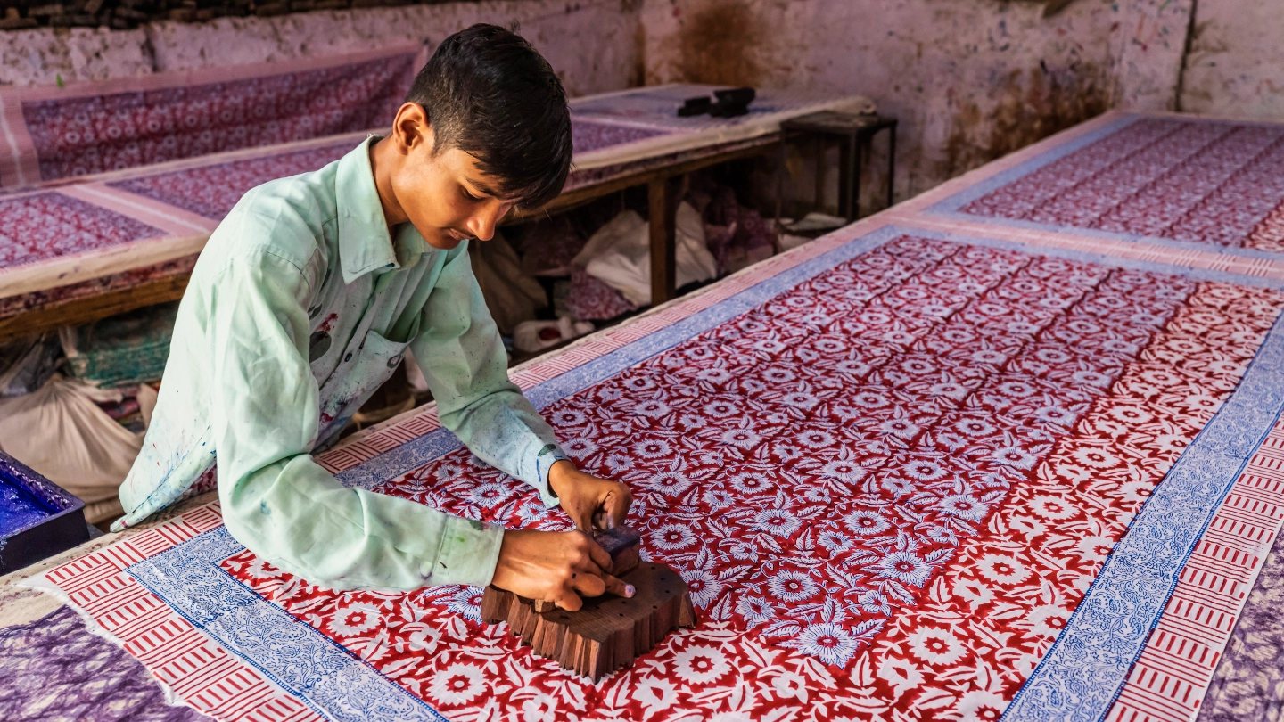 man block printing colourful fabric man block printing colourful fabric